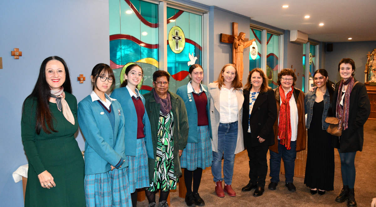 Students and staff, along with the artists, who contributed to the design and creation of the new stained glass windows in the Mercy Chapel.