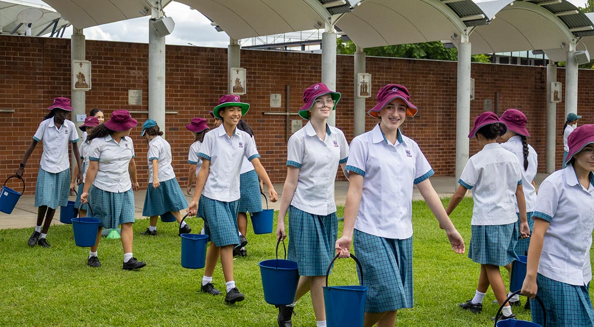 Catherine McAuley Westmead students carrying water buckets from St Patrick's Cathedral, Parramatta