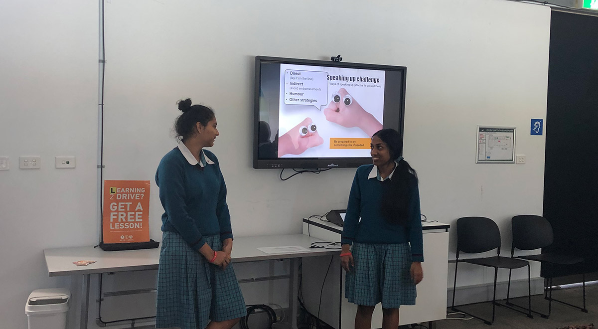 Two Catherine McAuley Students presenting to a large group at the Rotary Youth Driver Awareness (RYDA) Program