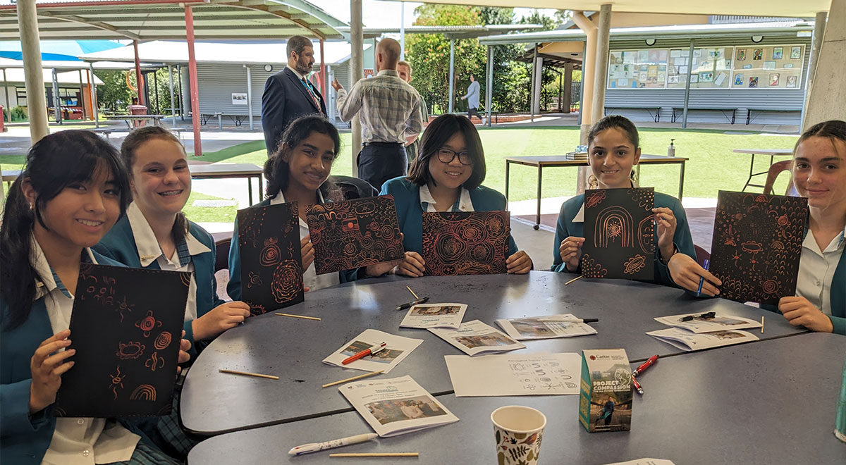 Year 9 students holding the artworks they completed at the launch