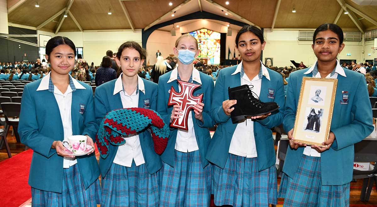 Catherine McAuley Westmead students holding items from the Mercy Day mass 2023