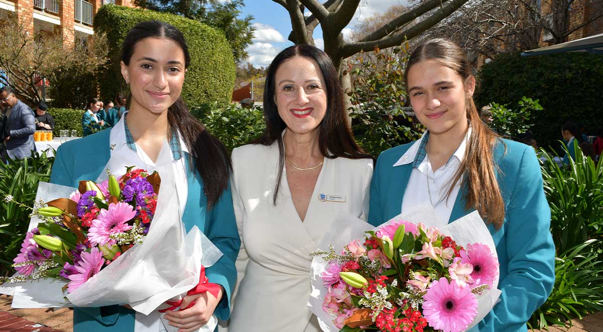 The 2023-2024 School Captains with School Principal Ms Mary Refalo - on left Alyssa A.and on right Lea Z.