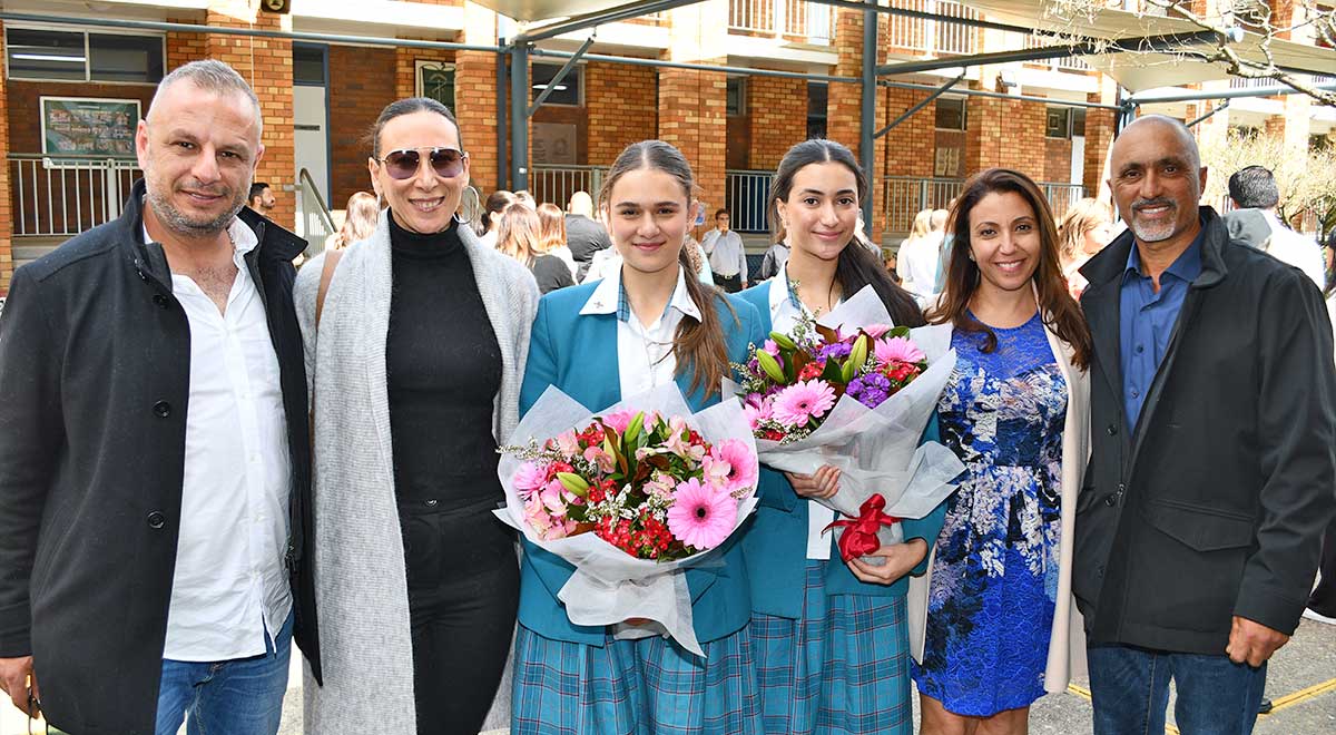 The new school captains Lea and Alyssa with their parents.