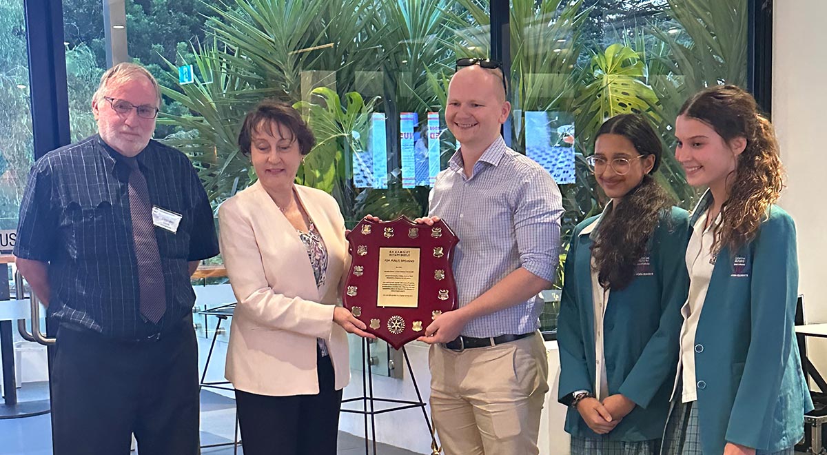Mr Thomas Fraser and Year 9 students Siya and Olivia being presented with the Clift Public Speaking Shield by Rotary Club of Parramatta members