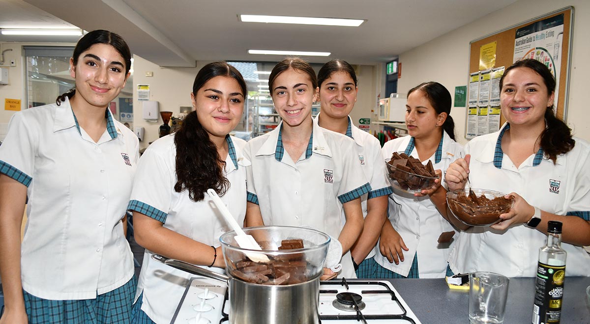 Year 9 Coolock and Ryan students melting chocolate for their chocolate and strawberries stall