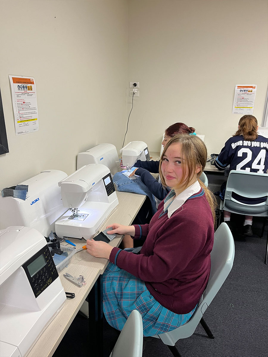 Student Fashion Designers from McAuley using sewing machines