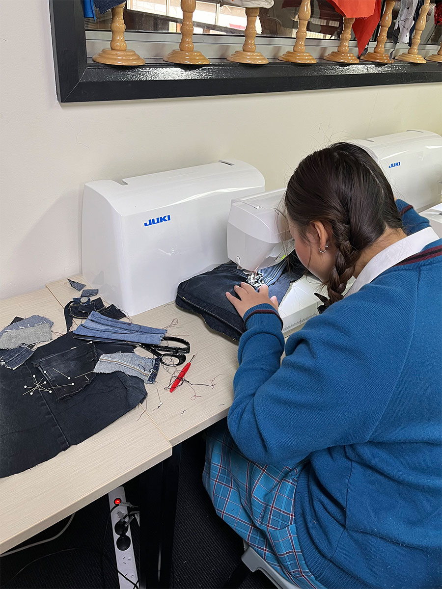 Student Fashion Designers from McAuley using sewing machines