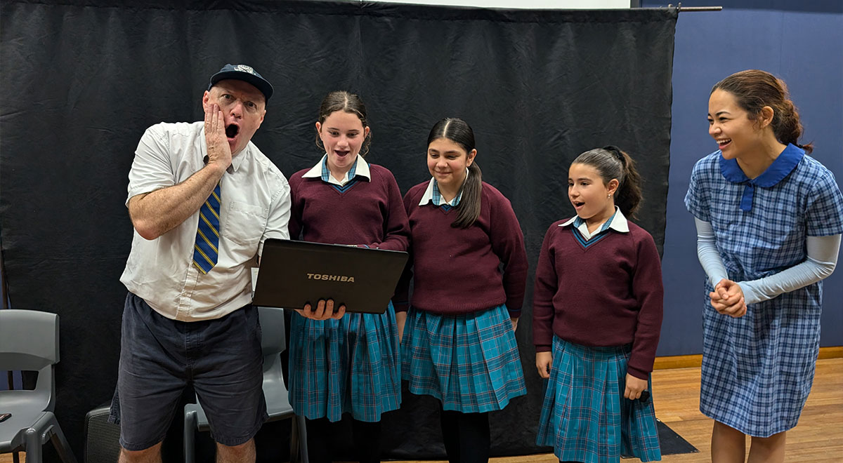 Year 7 students from Catherine McAuley Westmead posing with two actors
