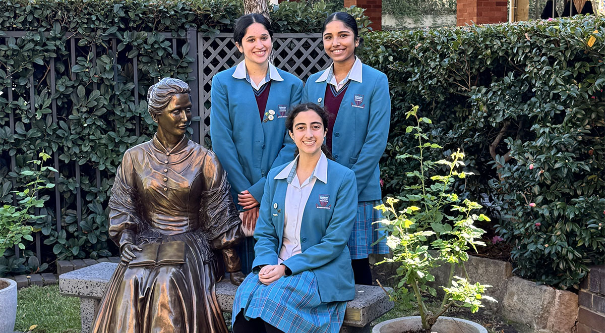 Students with the statue of Catherine McAuley, 'Come Sit Awhile', on the Mercy Heritage Trail.