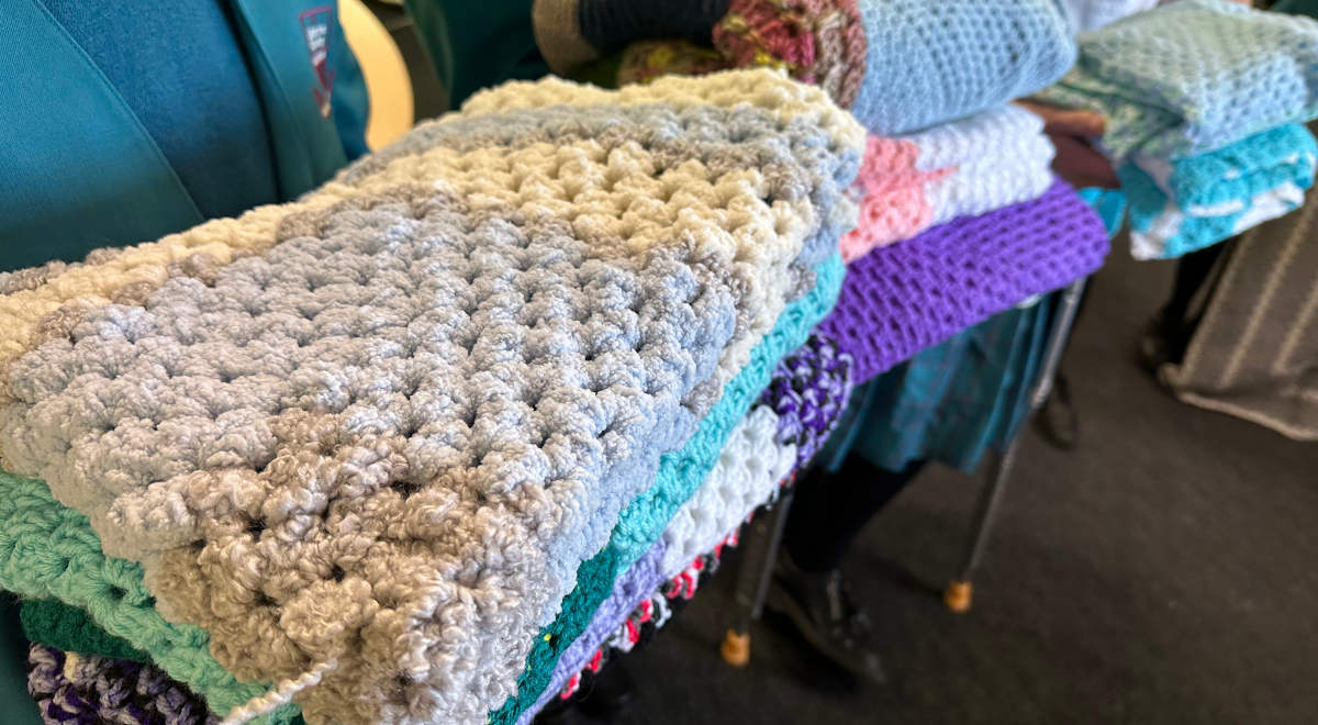 Blankets and gloves made by the Charity Crochet Group for donation to the Parramatta Women's Shelter.