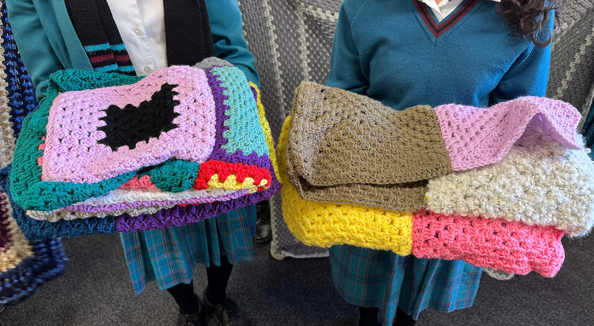 Blankets and gloves made by the Charity Crochet Group for donation to the Parramatta Women's Shelter.