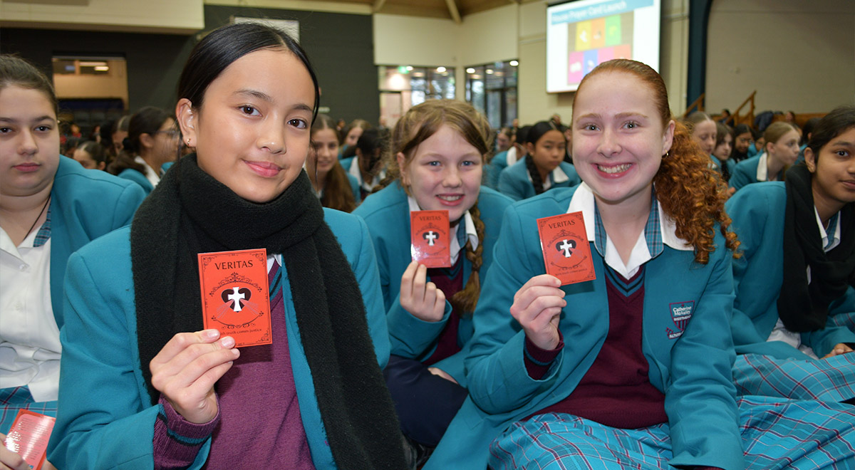 Catherine McAuley Westmead students holding prayer card