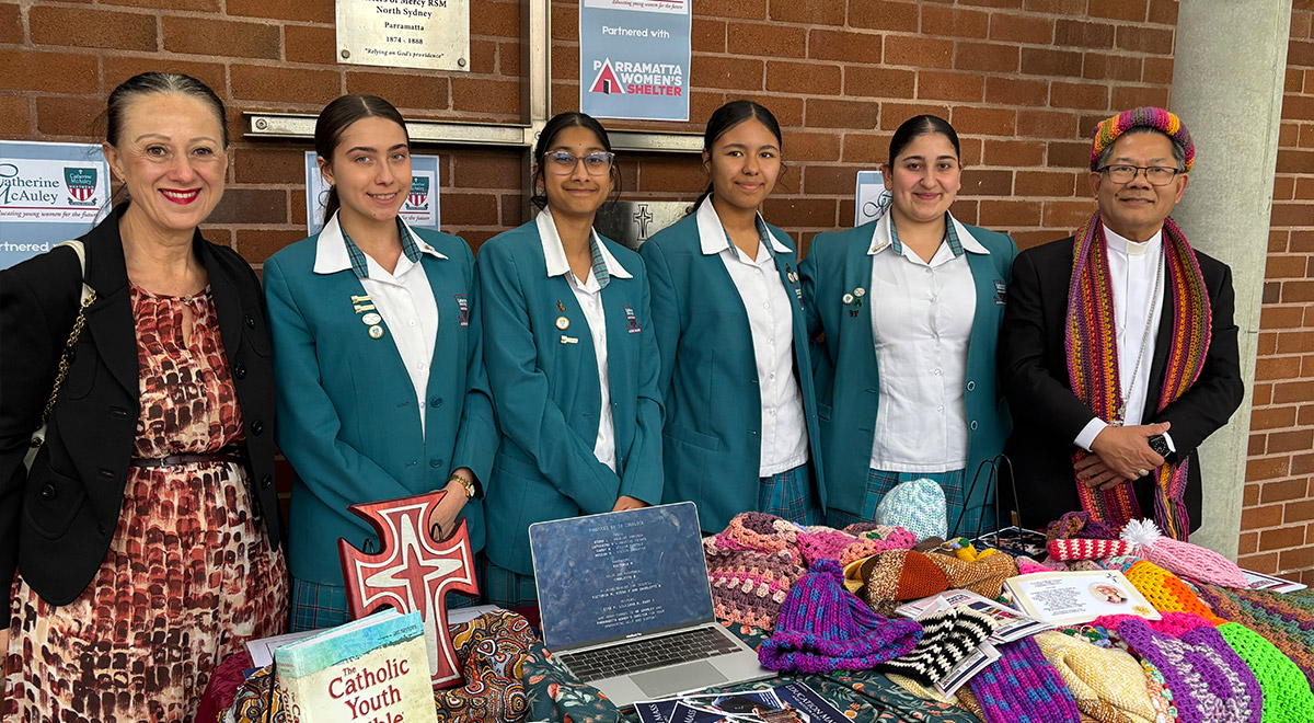  Year 10 students, with Bishop Vincent and Ms Refalo, showcasing the school's work for The Parramatta Women's Shelter.