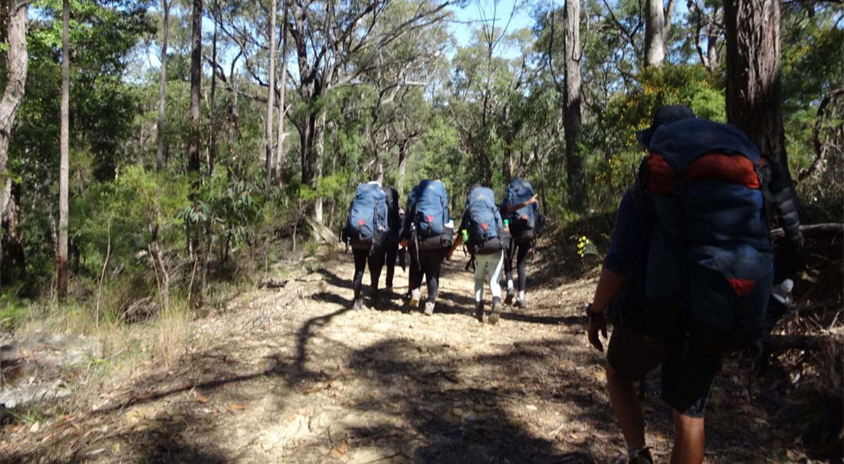 Year 9 Catherine McAuley Westmead students on their Bronze Duke of Edinburgh Adventurous Journey. They are hiking.