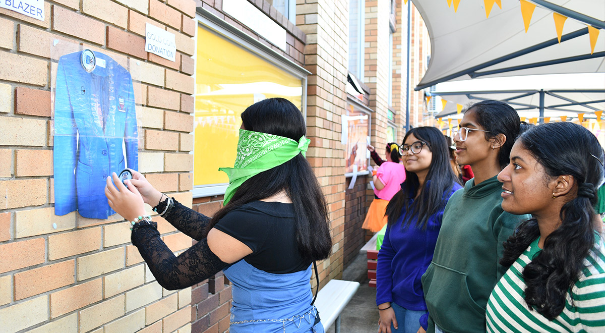 Students playing 'pin the badge on the blazer'