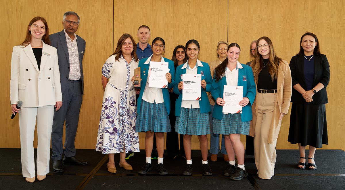 Year 10 Commerce students who were awarded 2nd place, with Macquarie University representatives and their teachers Mrs Noud and Ms Nicolson.