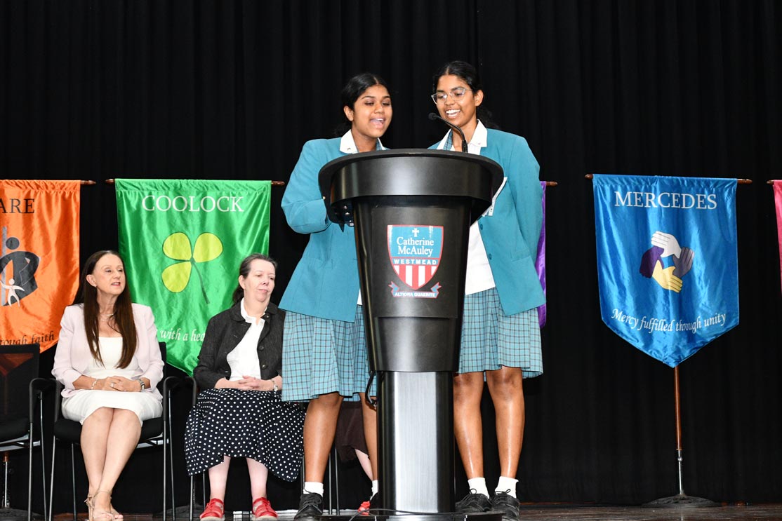 Shanelle W. and Latika N. speaking at school assembly
