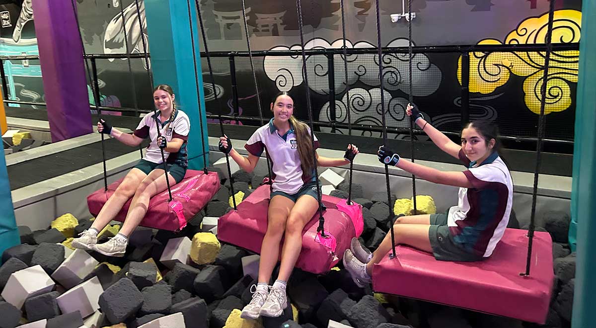 Catherine McAuley Westmead students crossing a pit of foam cubes at Tru Ninja Warrior
