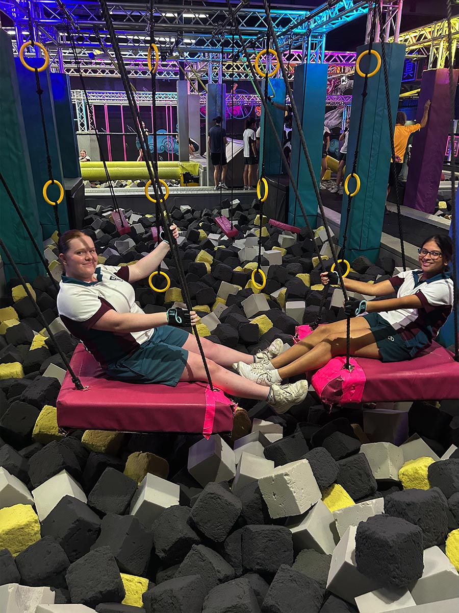 Catherine McAuley Westmead students crossing a pit of foam cubes at Tru Ninja Warrior
