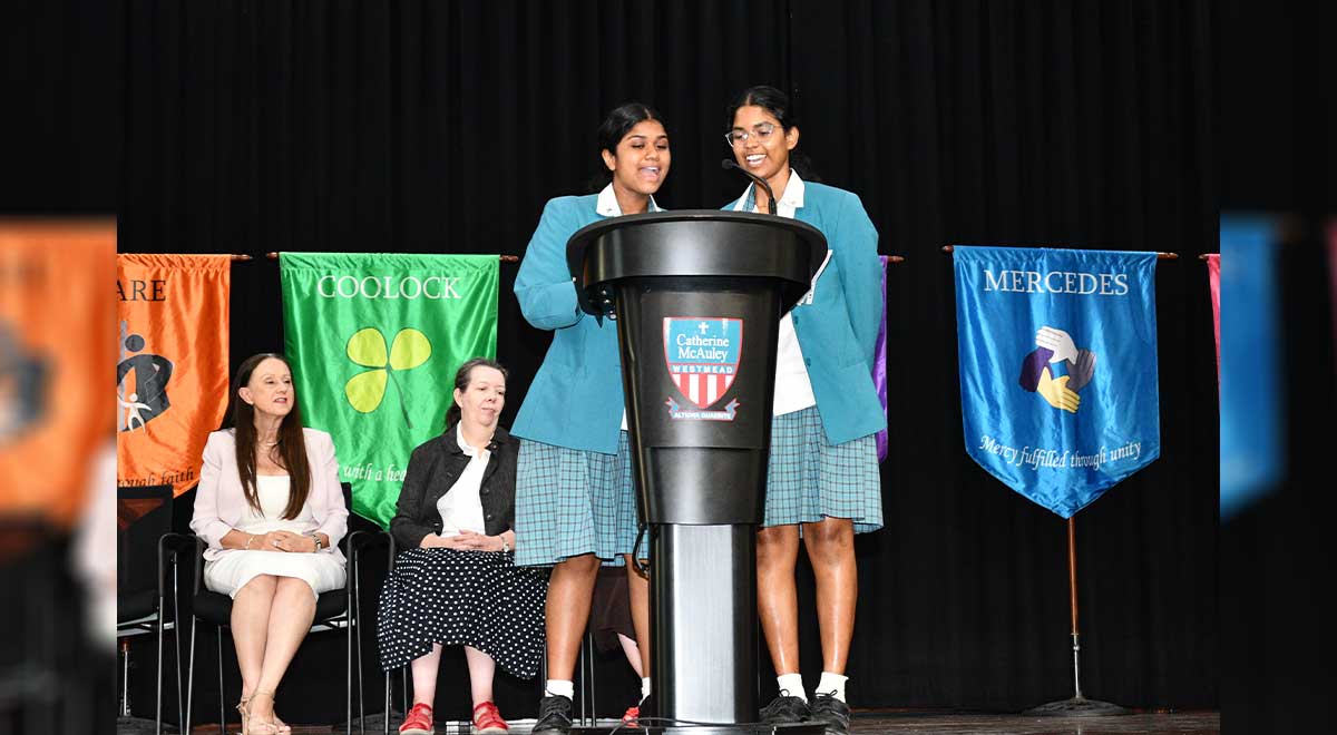 Shanelle W. and Latika N. speaking at school assembly