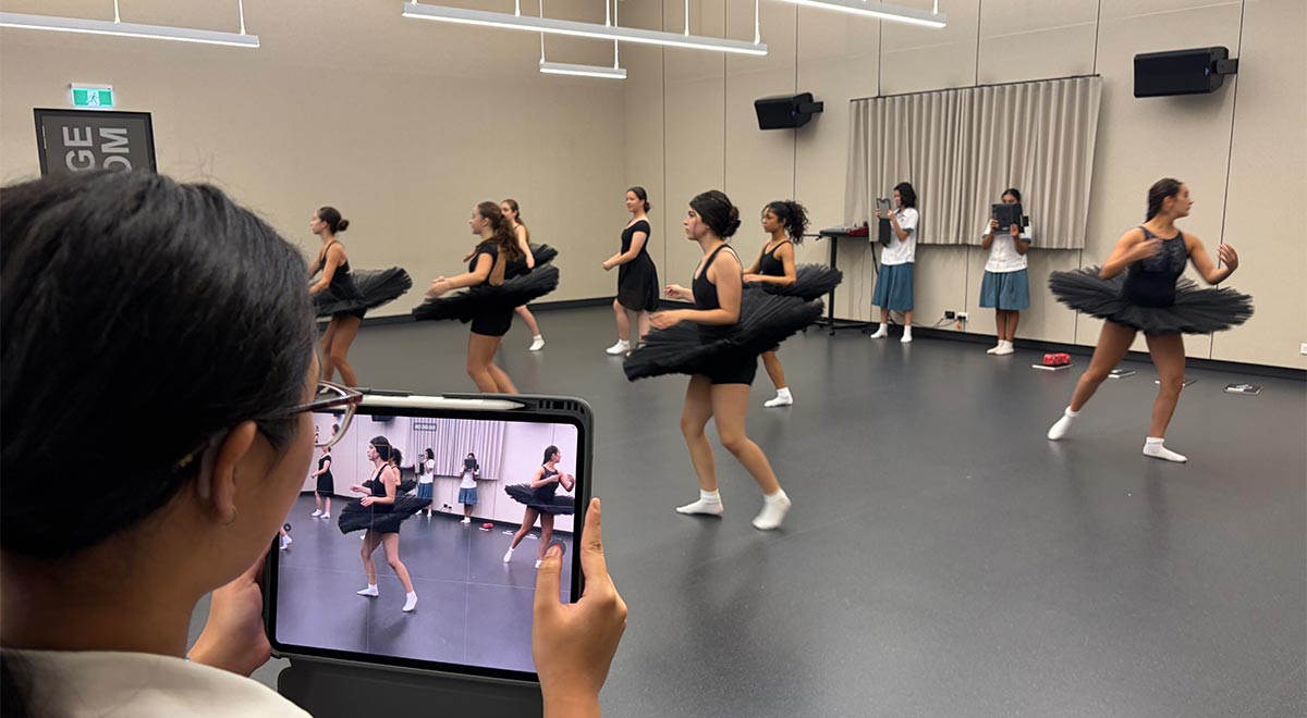 Year 10 Visual Arts student taking photograph of dance students