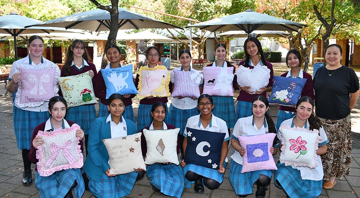 Year 9 Textiles students with the cushions they created.