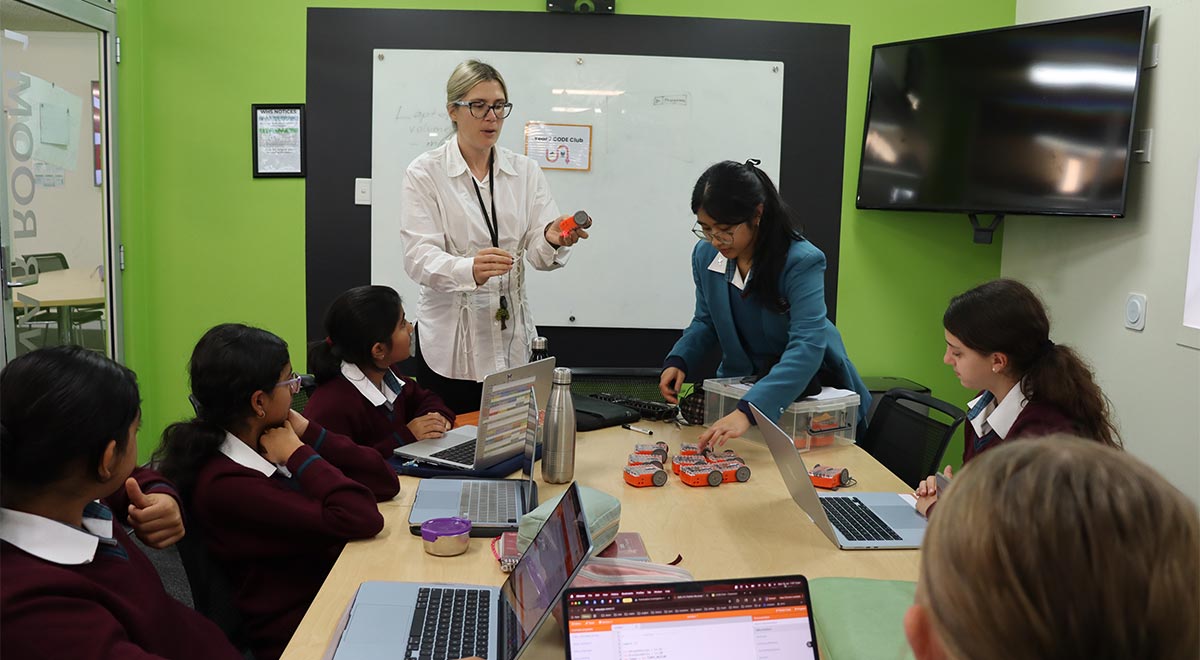 Mrs T. Hartman, Teacher Librarian, explaining to the Year 7 students how to program the Edison robots.