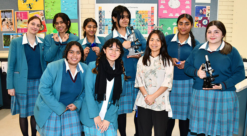 Teacher and group of happy students at Catherine McAuley Catholic College Westmead