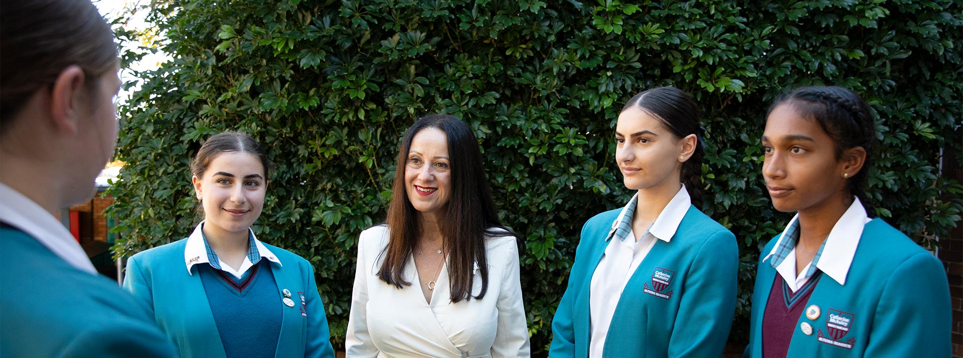 Mary Refalo, Principal of Catherine McAuley Westmead, talking with students in school courtyard