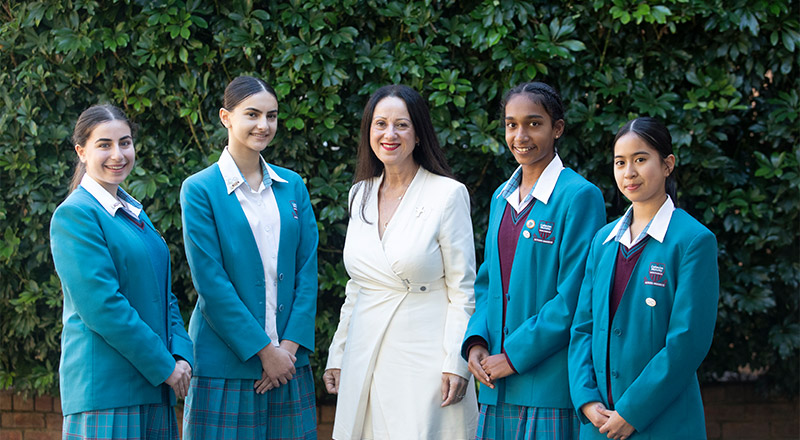 Mary Refalo, Principal of Catherine McAuley Westmead, talking with students in school courtyard